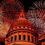 Colorful fireworks burst over a modern tech building at night, symbolizing innovation and breakthrough in real-time WebRTC streaming.